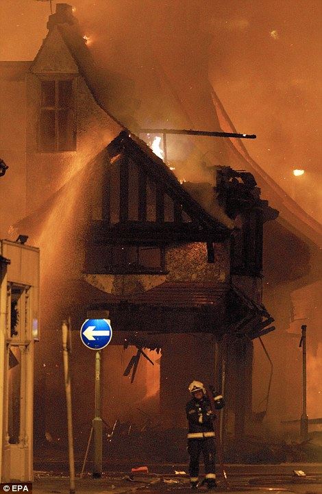 firemen lifts hose attends the fire the House Reeves furniture shop Church StreetCroydon